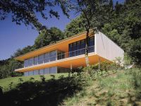 Moderní, individuálně pojatá dřevostavba zasazena do přírody.